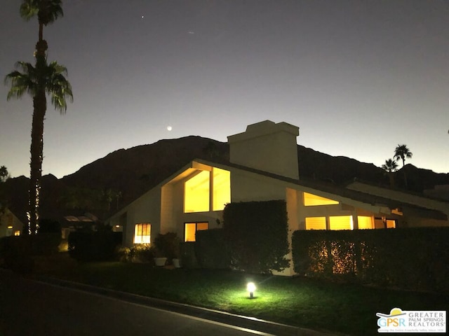 view of side of home with a mountain view