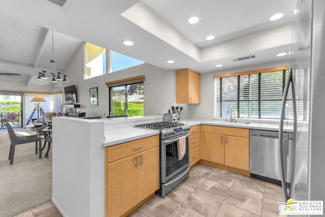 kitchen featuring sink, light brown cabinets, kitchen peninsula, light carpet, and appliances with stainless steel finishes