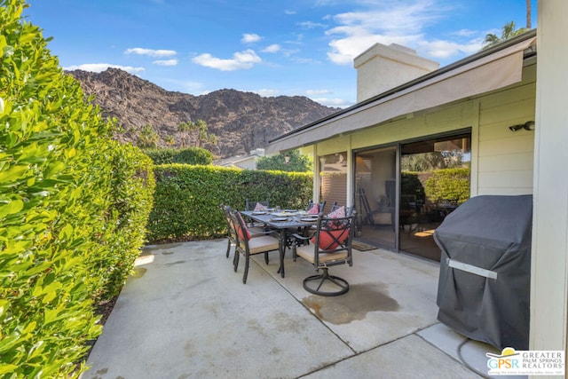 view of patio with a mountain view and grilling area