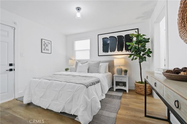 bedroom with hardwood / wood-style flooring