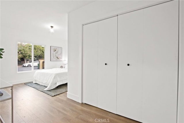 unfurnished bedroom featuring light hardwood / wood-style flooring and a closet