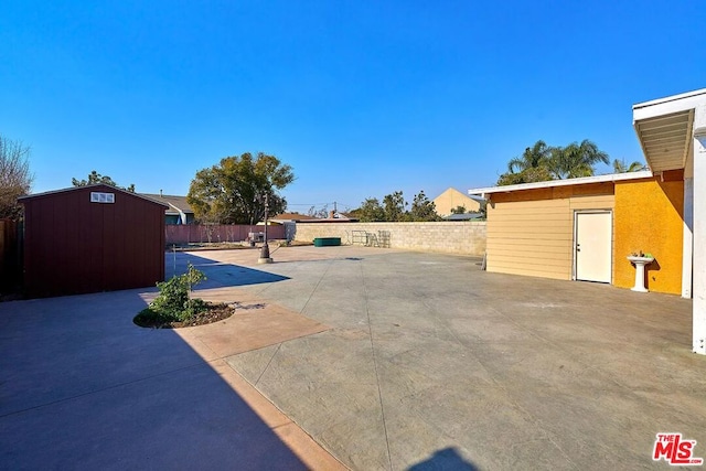 view of patio featuring a storage shed