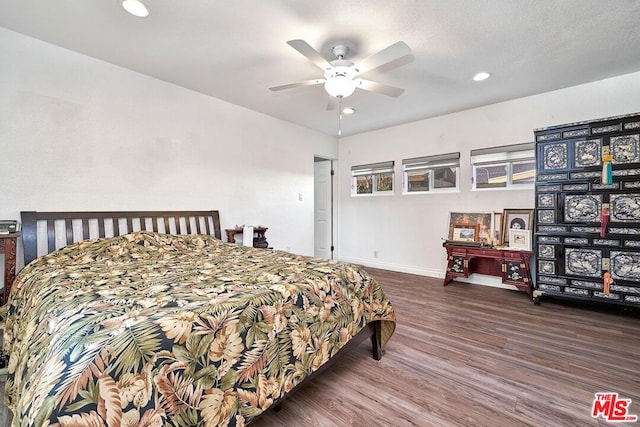 bedroom with ceiling fan and dark wood-type flooring