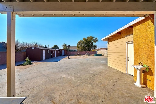 view of patio with a storage shed