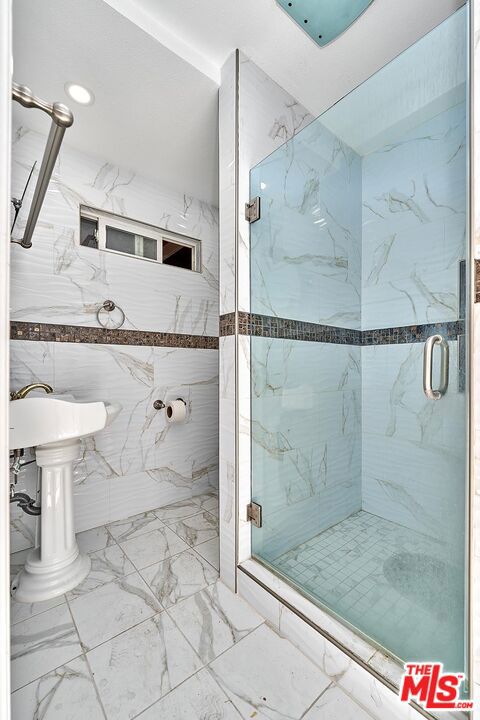 bathroom with a shower with door