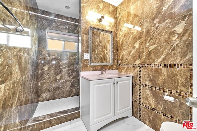 bathroom featuring a shower, vanity, toilet, and tile walls