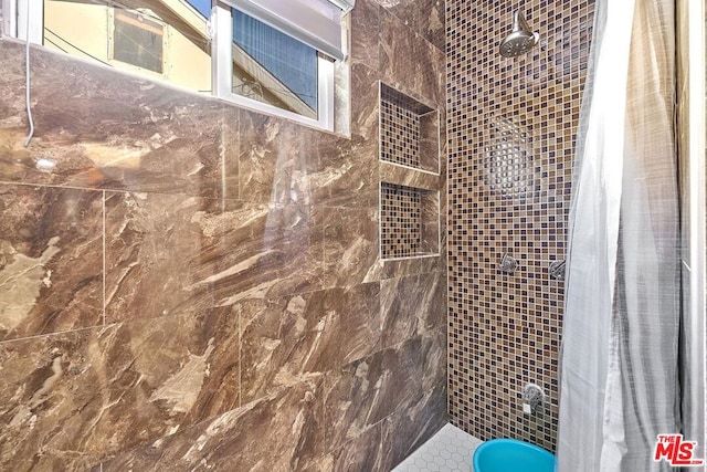 bathroom with tiled shower