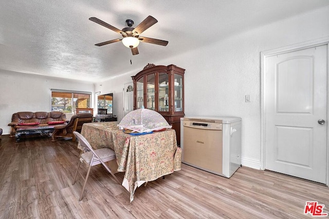 bedroom featuring ceiling fan, a textured ceiling, and light wood-type flooring