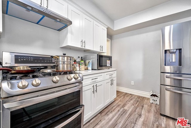 kitchen featuring light wood-type flooring, stainless steel appliances, and white cabinetry