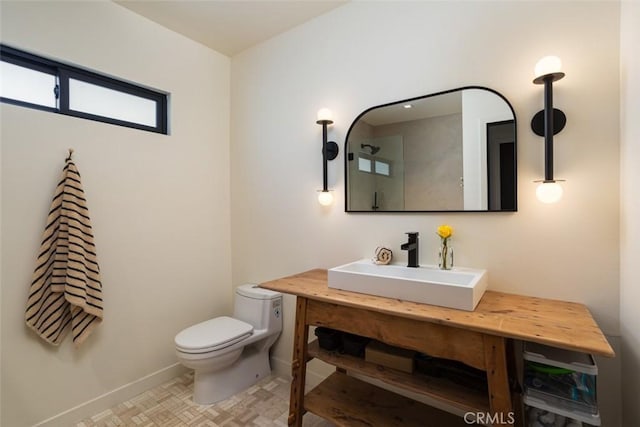 335 Flint Ave, Long Beach, CA 90814 - bathroom featuring toilet, vanity, and baseboards