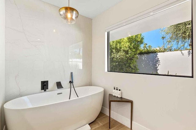 bathroom with a tub to relax in