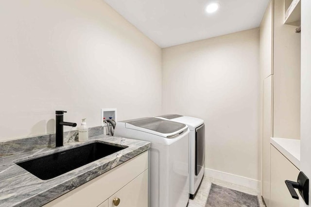 laundry area with washing machine and clothes dryer and sink