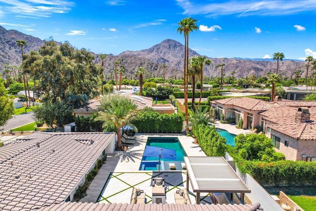 view of pool featuring a patio area and a mountain view