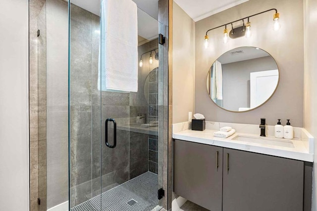 bathroom featuring vanity and a shower with shower door