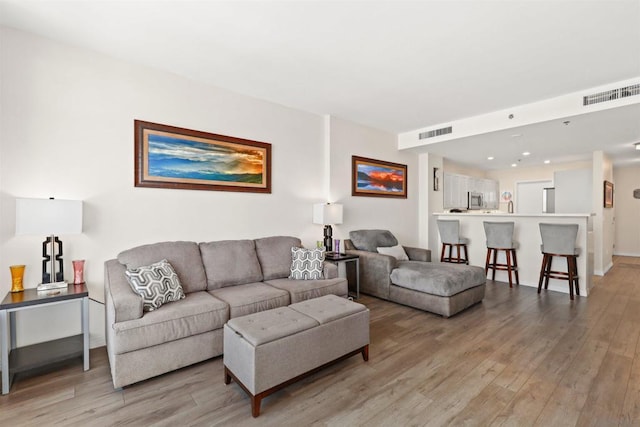 living room with light hardwood / wood-style flooring