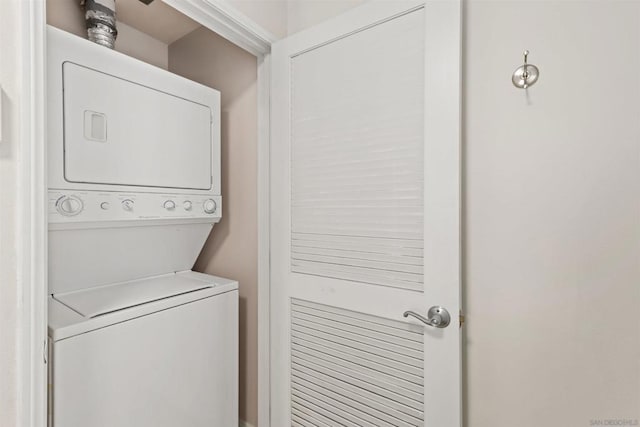 laundry room with stacked washer / dryer