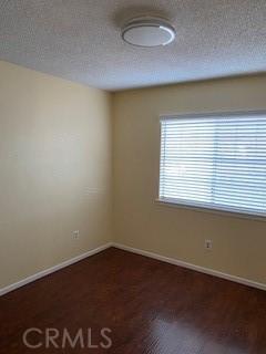 spare room with dark hardwood / wood-style floors