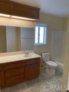 bathroom with tile patterned flooring, vanity, and toilet