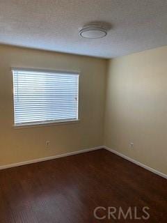 empty room featuring dark hardwood / wood-style floors