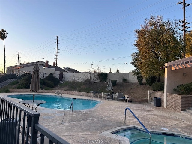 view of pool featuring an in ground hot tub and a patio