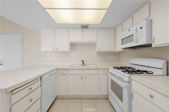 kitchen with sink, light tile patterned floors, white cabinets, and white appliances