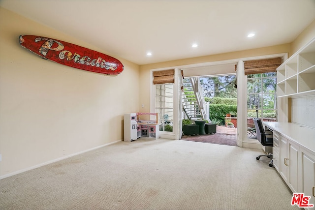 unfurnished office featuring light carpet and plenty of natural light