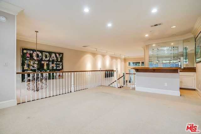 living room featuring crown molding, rail lighting, and light carpet