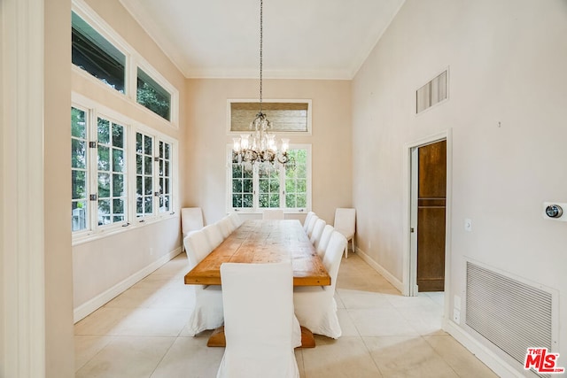 tiled dining room with a towering ceiling and a notable chandelier