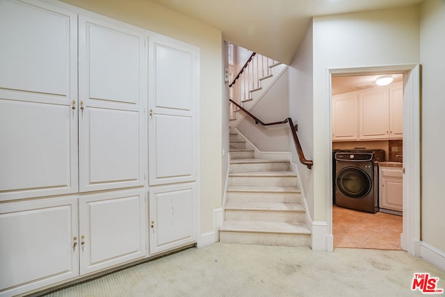 stairway featuring washer / dryer and carpet floors