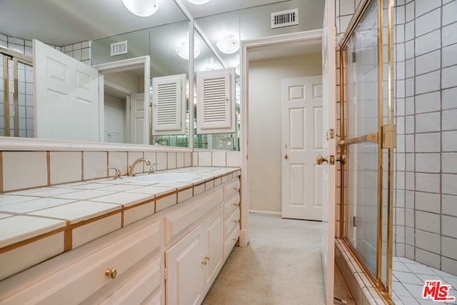 bathroom with vanity and walk in shower