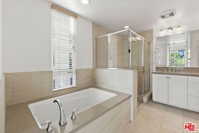 bathroom featuring vanity, separate shower and tub, and tile patterned floors