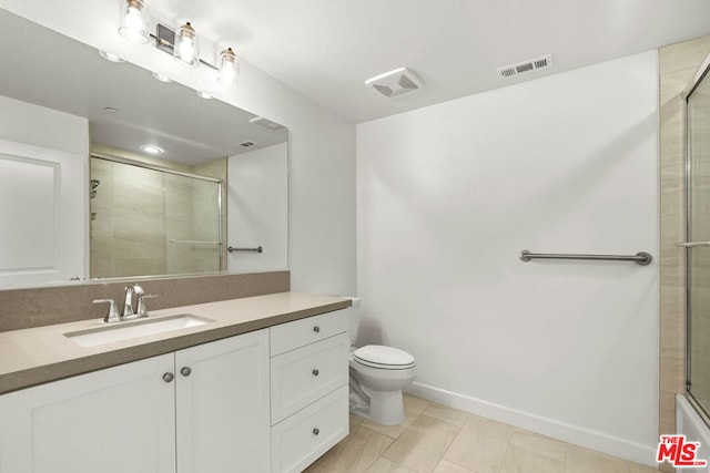 bathroom featuring walk in shower, tile patterned floors, vanity, and toilet