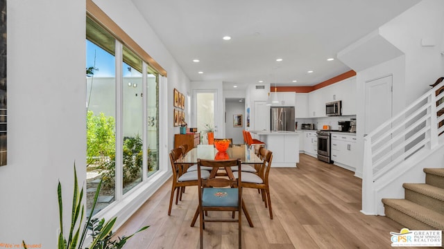 dining area featuring plenty of natural light and light wood-type flooring