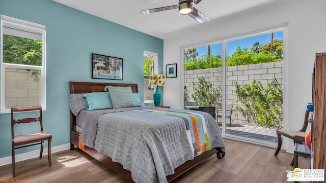 bedroom with access to exterior, ceiling fan, and light hardwood / wood-style flooring