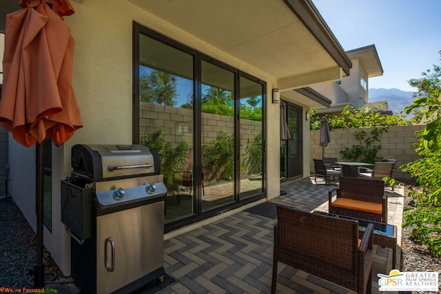 view of patio / terrace with a mountain view and grilling area