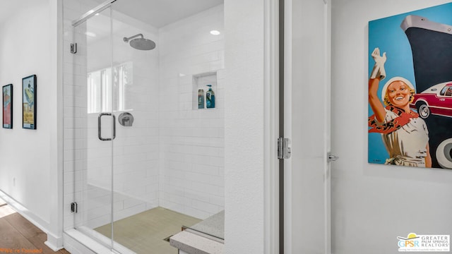 bathroom featuring a shower with shower door