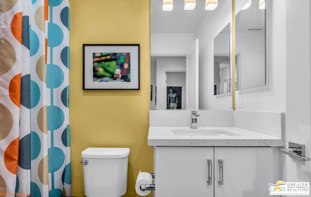 bathroom with vanity and toilet