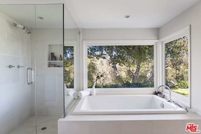 bathroom featuring separate shower and tub