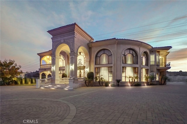 view of outdoor building at dusk