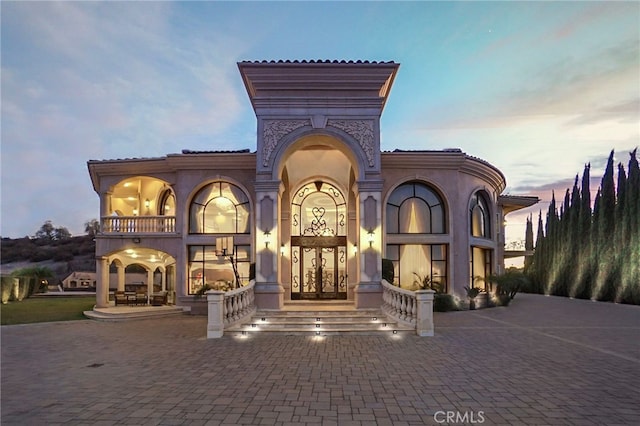 view of outdoor building at dusk