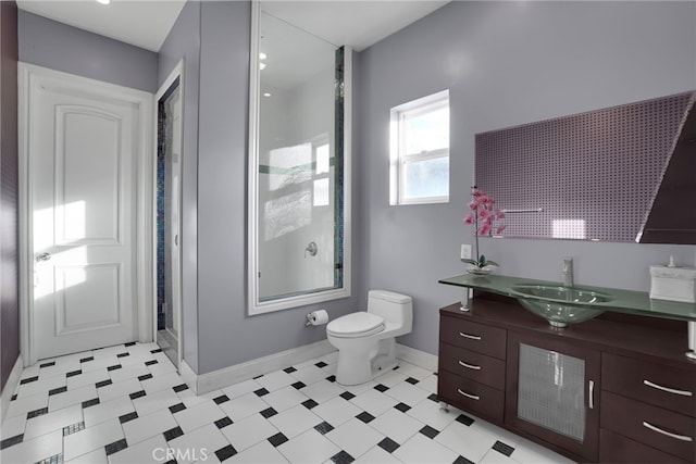 bathroom with walk in shower, vanity, and toilet