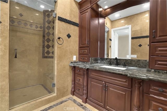 bathroom with vanity and a shower with shower door