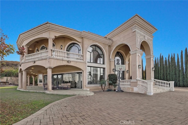 back of house with a patio area and a balcony