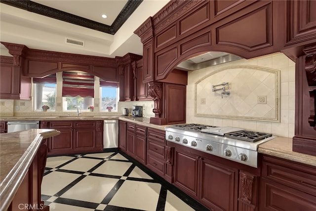 kitchen featuring premium range hood, crown molding, sink, appliances with stainless steel finishes, and tasteful backsplash