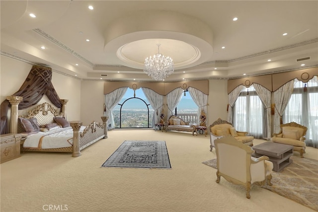 carpeted bedroom with a tray ceiling, ornamental molding, and an inviting chandelier