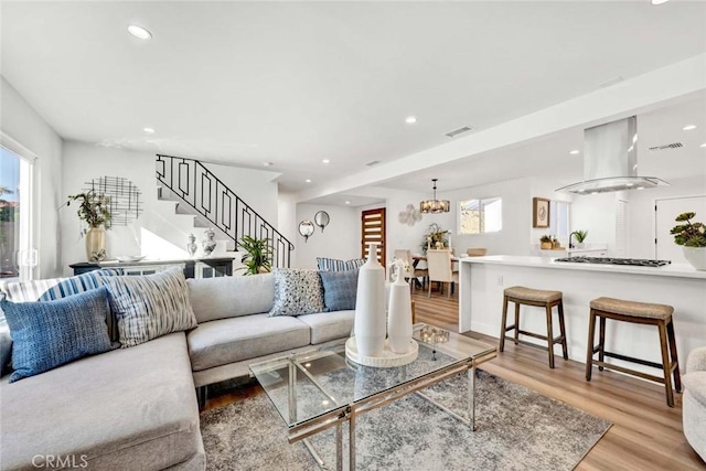 living room featuring light hardwood / wood-style floors and an inviting chandelier