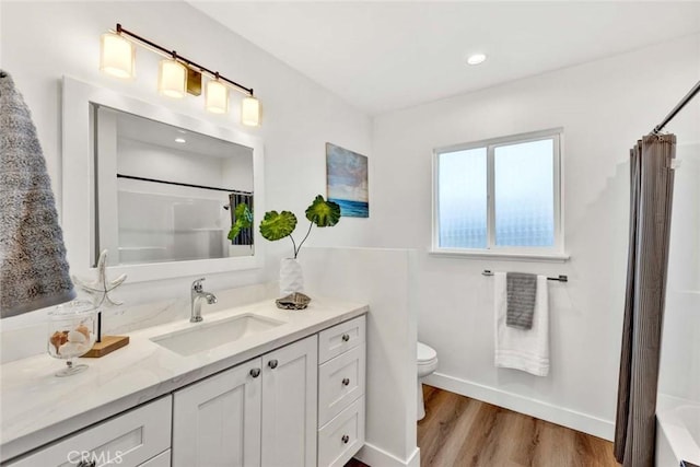 full bathroom featuring toilet, vanity, shower / bath combo, and hardwood / wood-style floors