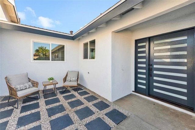 view of exterior entry featuring a patio area