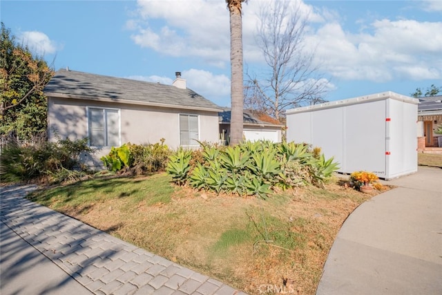 view of property exterior with a yard