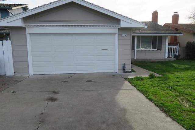 view of front of home with a garage and a front lawn